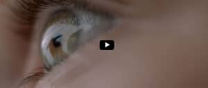 Close-up of a Human Eye with a Play Button Overlay, Indicating a Video to Play