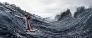 Orange Rescue Lifeboat Amid Towering Dark Ocean Waves and White Spray Under a Cloudy Sky, Stormy Sea Scene.